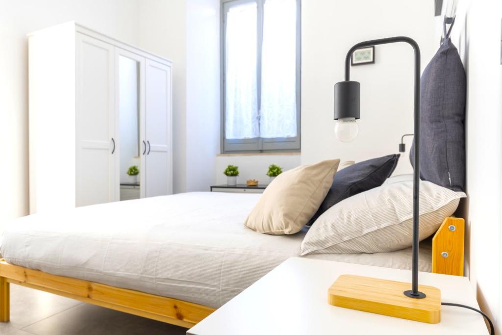 A bed or beds in a room at Hostly - Nicole Apartment Volturno- Full Rome Center