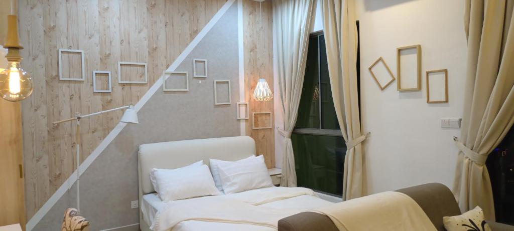 a living room with a white couch and a staircase at Peace home apex in Cyberjaya