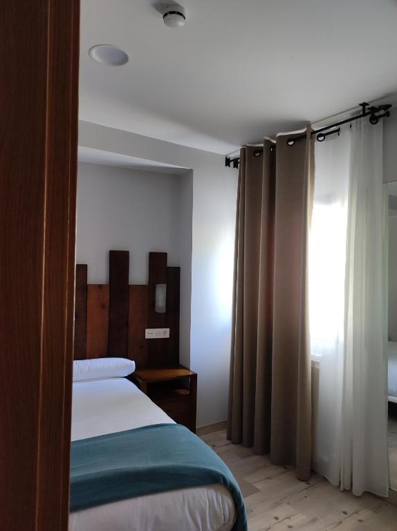 Postel nebo postele na pokoji v ubytování El Capricho de Arguis