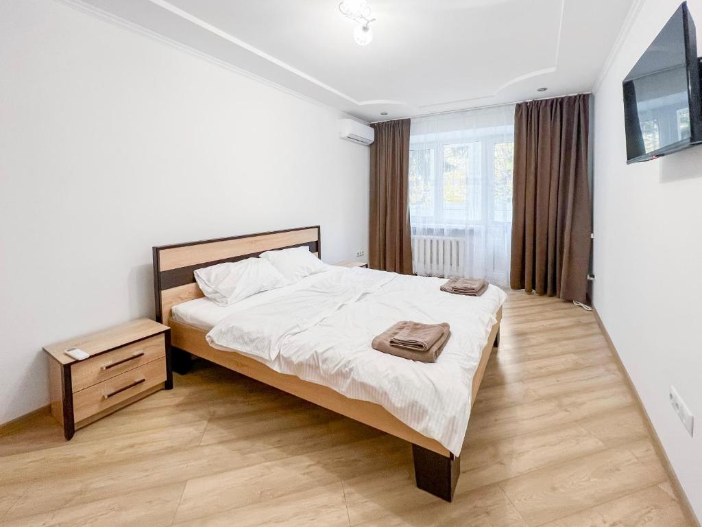 1 dormitorio con 1 cama y TV en Апартаменти по вул Галицька, en Ivano-Frankivsk