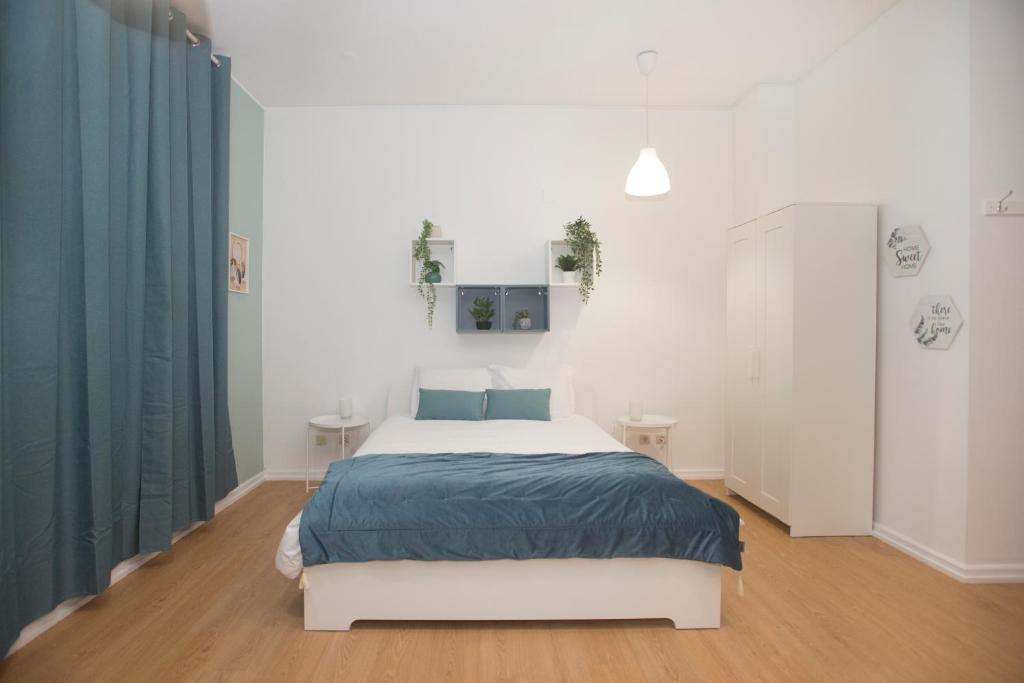 En eller flere senge i et værelse på Bonsai Apartment III