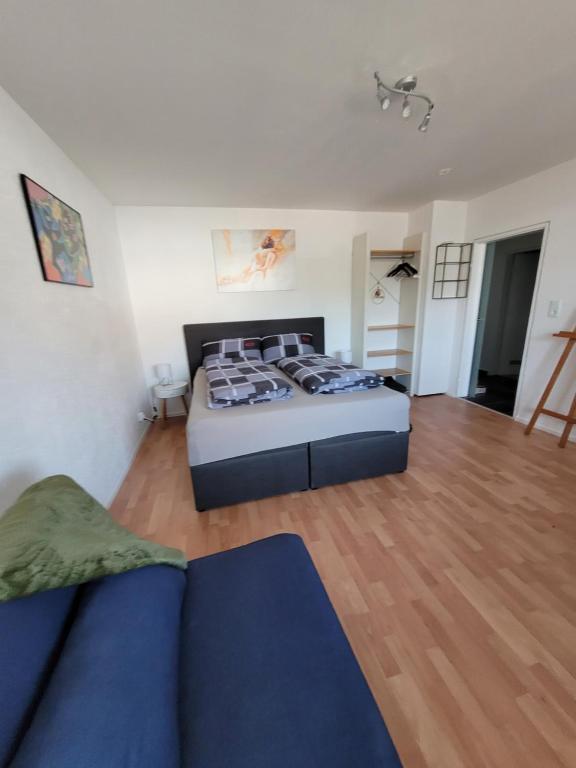 a large bedroom with a bed and a couch at Business Apartment in Rheinfelden(Baden) in Rheinfelden