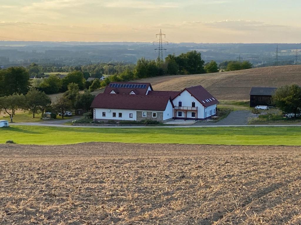 a house on top of a hill with a field at Hofbauer-Hof in Rastenfeld