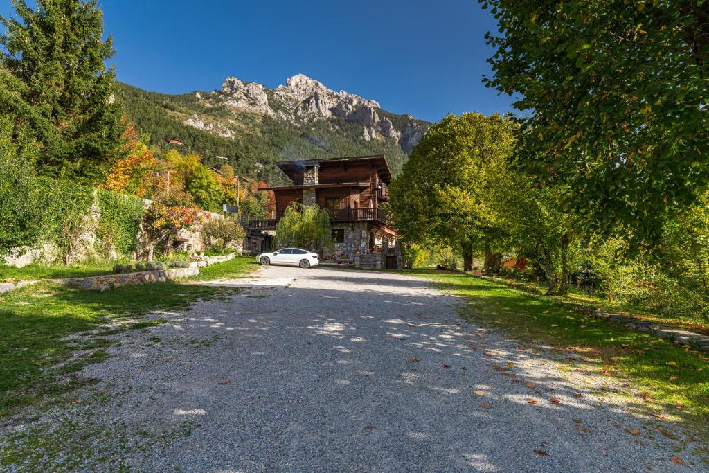 a house with a car parked on the side of a road at Chambres d'hôtes les Murès du Mercantour in Valdeblore