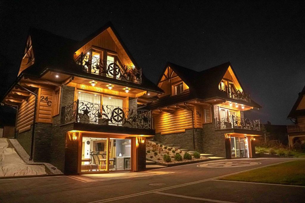 a large house at night with its lights on at WILLA GRG in Zakopane
