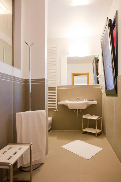 a bathroom with a sink and a mirror at Hotel Marco Polo in Lido di Jesolo