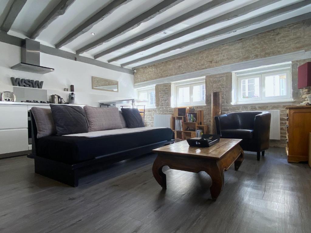 a living room with a couch and a coffee table at Wood Stone and Wine in Beaune