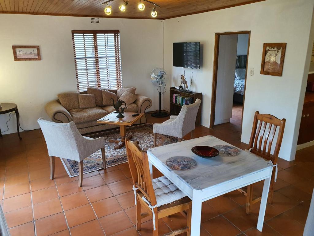 a living room with a table and chairs at Aurora Bushbaby 1 in Centurion