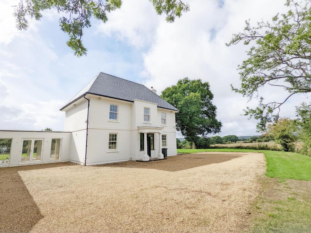 een wit huis met een grindoprit bij The White House - Bordon in Bordon