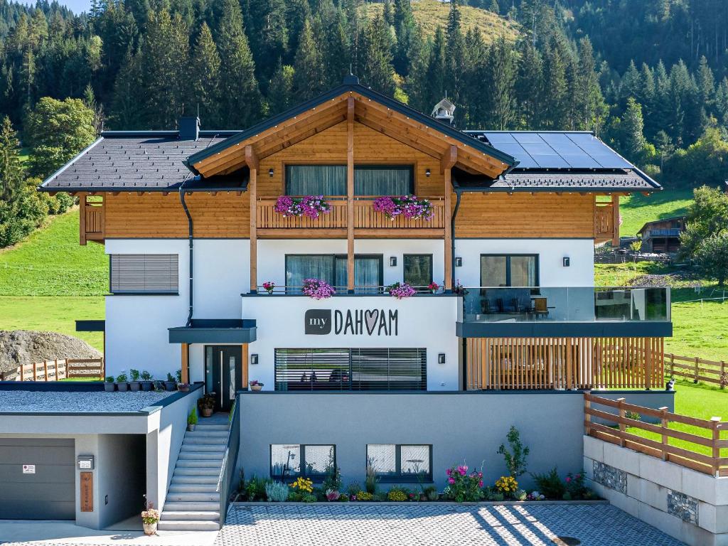 a house with solar panels on the roof at My Dahoam in Eben im Pongau