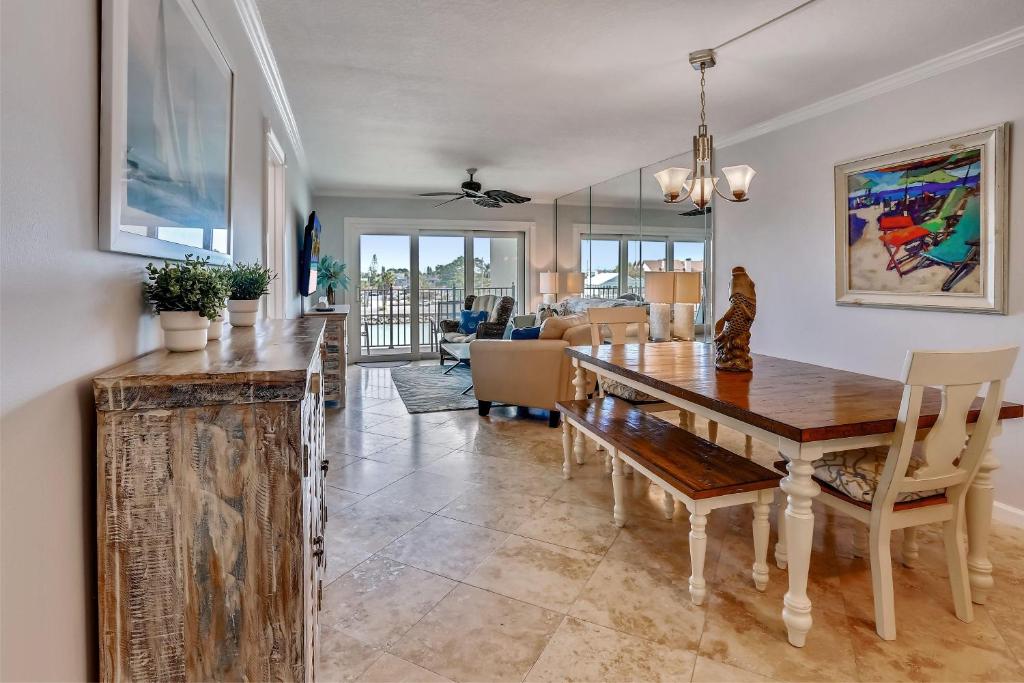 a dining room with a table and chairs and a living room at Land's End 4-303 Bay Front - Premier in St Pete Beach