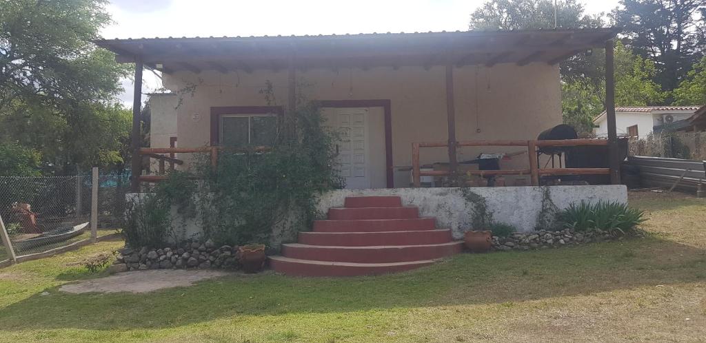 a house with a set of stairs in front of it at Casa con Gran Patio in Villa Parque Siquiman