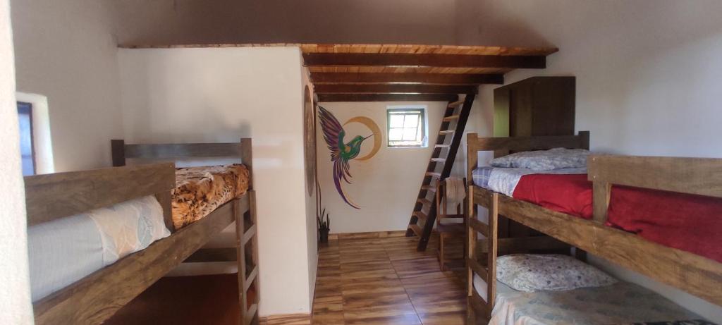 Postel nebo postele na pokoji v ubytování Espaço Cultural Lotus - Suítes, Hostel e Camping