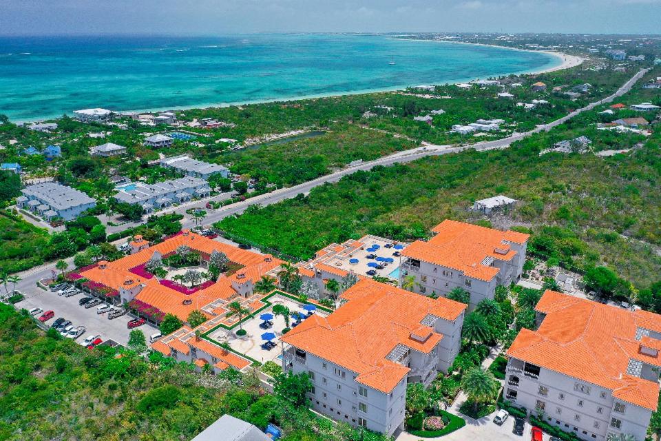 an aerial view of a building next to the ocean at Sea Esta Studio II - Ocean Views from Pool! in Turtle Cove