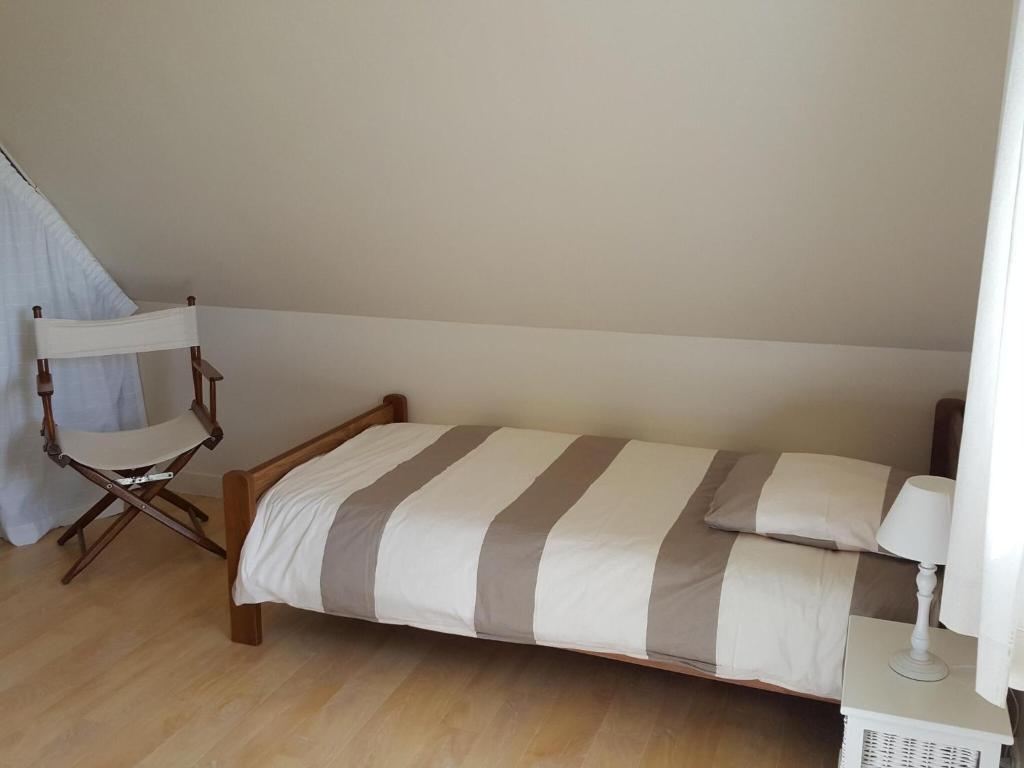 a bedroom with a bed and a chair and a desk at Holiday home with sea views, Plounéour-Brignogan-Plages in Plounéour-Trez