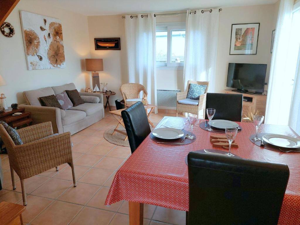 a living room with a table and chairs and a couch at Holiday home with sea views, Plounéour-Brignogan-Plages in Plounéour-Trez