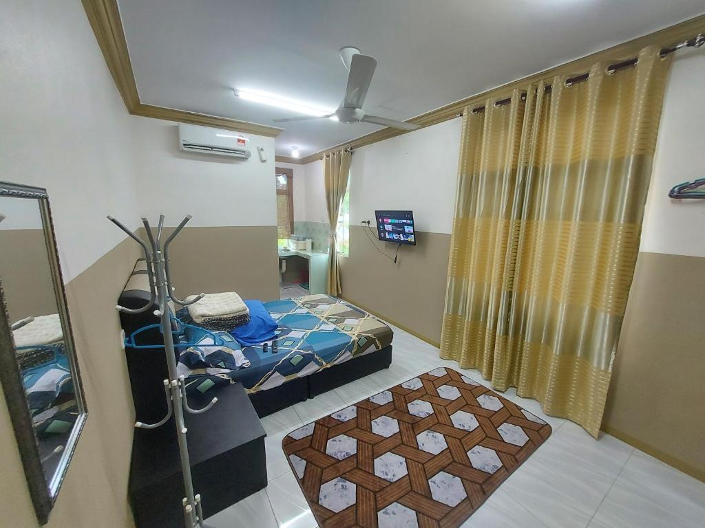 a hospital room with a bed and a mirror at A n H Homestay in Kota Bharu