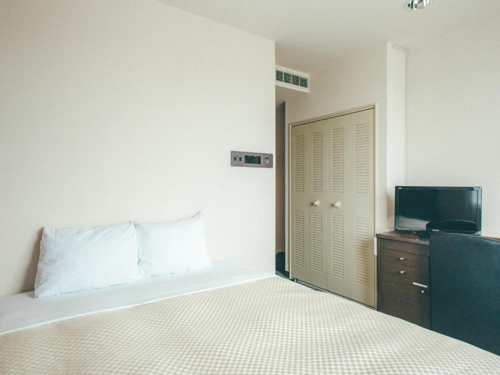 Ένα ή περισσότερα κρεβάτια σε δωμάτιο στο Toyohashi Station Hotel / Vacation STAY 65494
