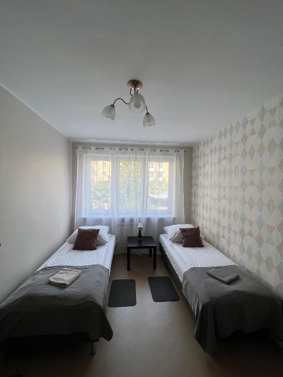 Posteľ alebo postele v izbe v ubytovaní Abra IV Apartament