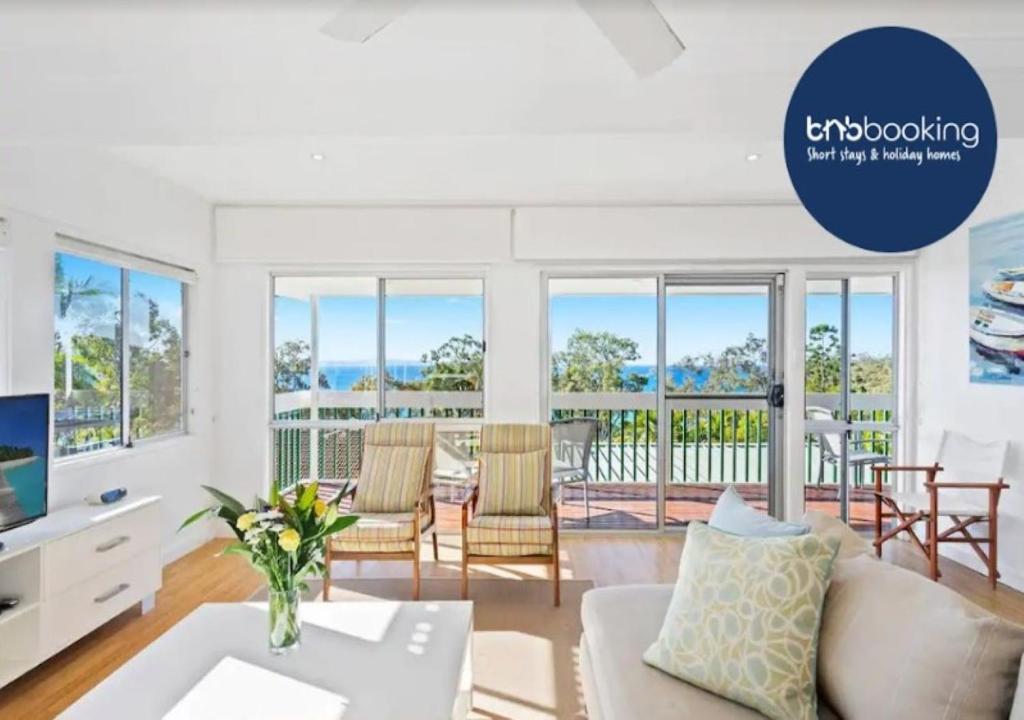 a living room with a couch and a table at Noosa Escape 2Br Allambi Rise in Noosa Heads