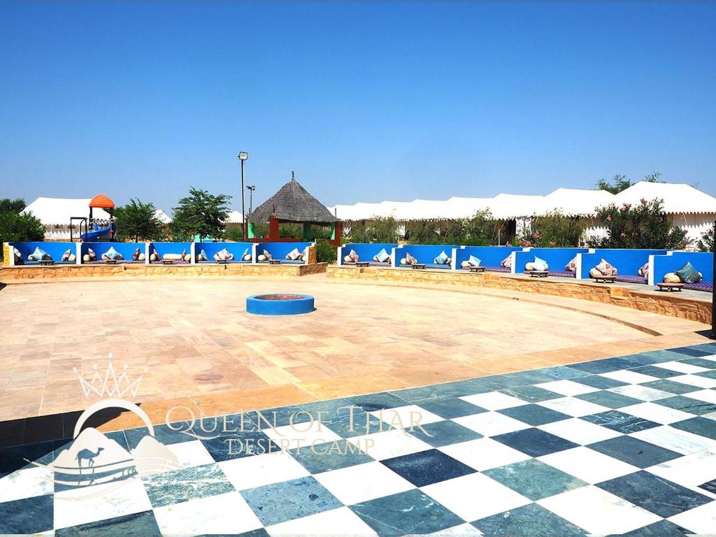 a large volleyball court in a resort with a checkered floor at Queen of Thar Desert Camp in Sām