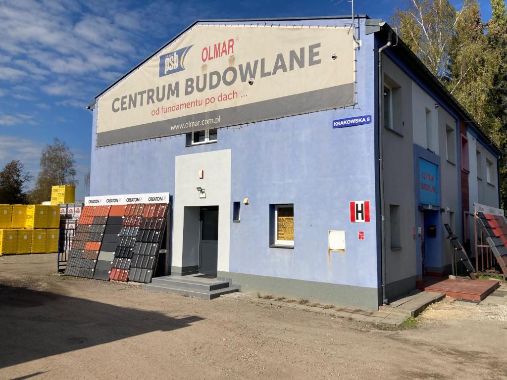 a blue building with a sign that reads carium bubble appliance at Hostel przy Stadionie in Jaworzno