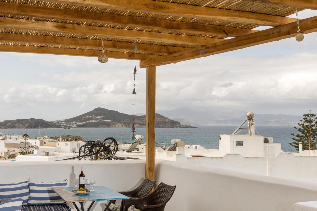 a table and chairs on a balcony with a view of the ocean at Elizabeth's small apartment in Naxos Chora