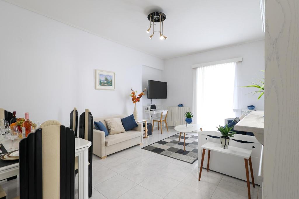 a living room with a couch and a table at Seaside Penthouse in Kalamata in Kalamata