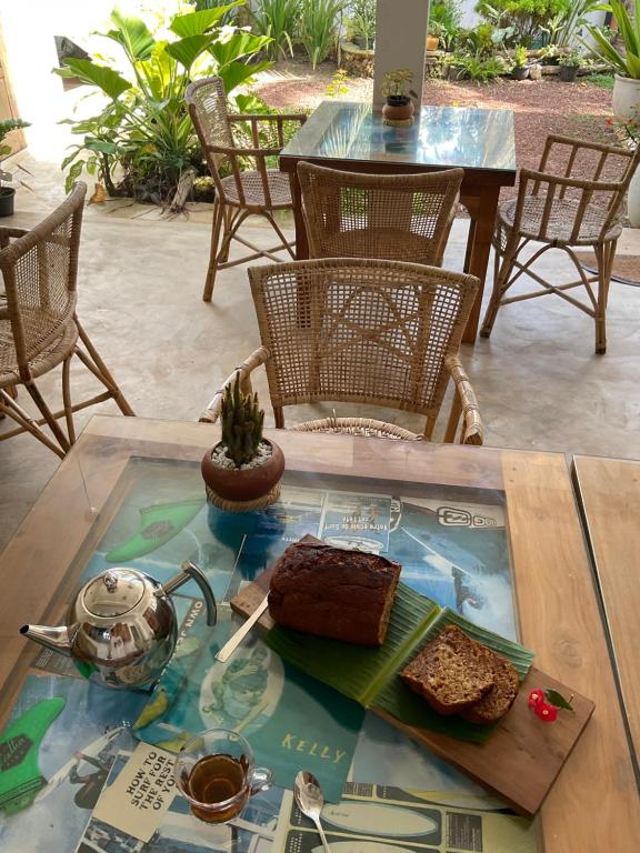 a table with a tray of food on top of it at Swallow villa - French guest house in Ahangama