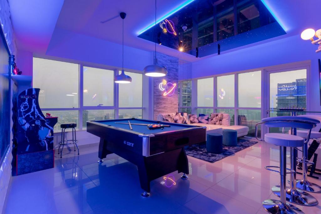 a living room with a pool table in it at Skyview Host in Dubai