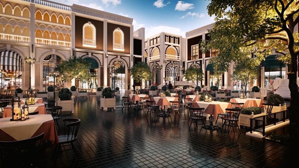a restaurant with tables and chairs in a mall at Kassland Resort & Spa -By Kassland Hotels in Ma'ale Adumim