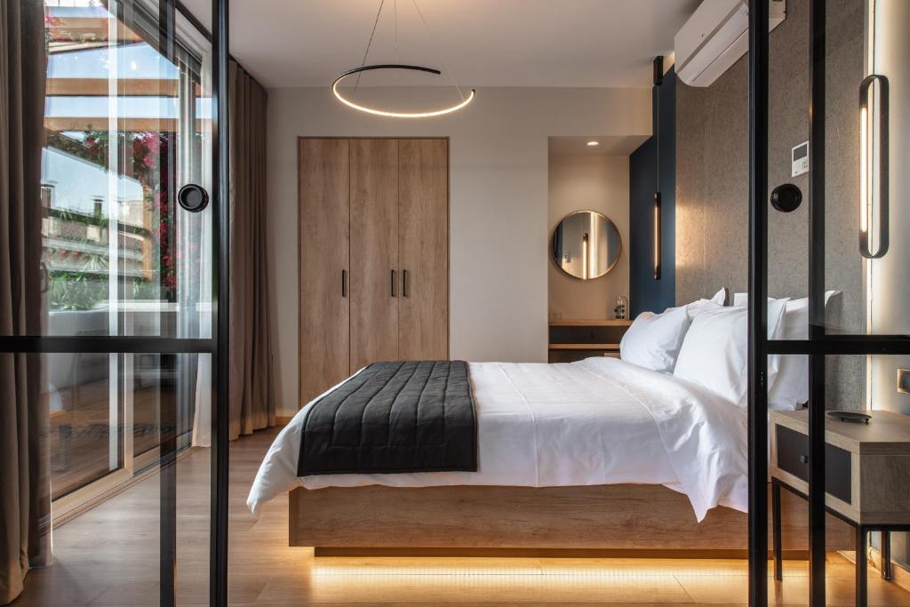 a bedroom with a white bed and a mirror at Ethereal Athεns in Athens