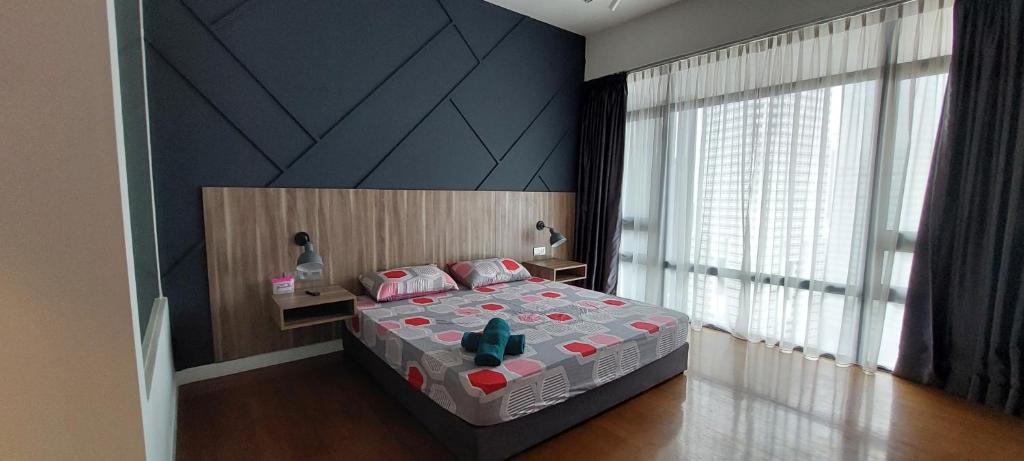 a bedroom with a bed and a large window at Anggun Presidential Suites in Kuala Lumpur