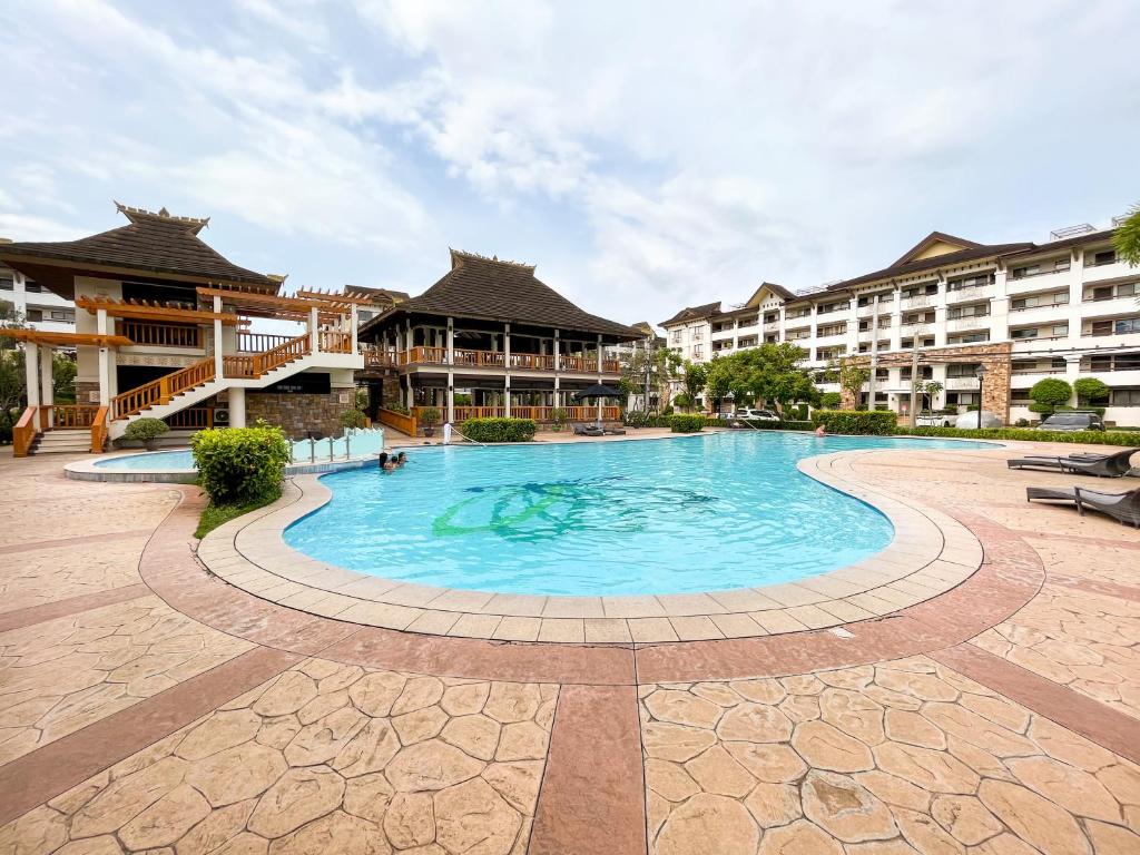 a swimming pool in the middle of a resort at Modern 2BR Condo Near SM with Free Parking Pool WIFI and Netflix in Davao City