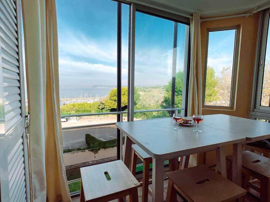 a dining room with a table and a large window at T3 vue mer exceptionnelle in Six-Fours-les-Plages