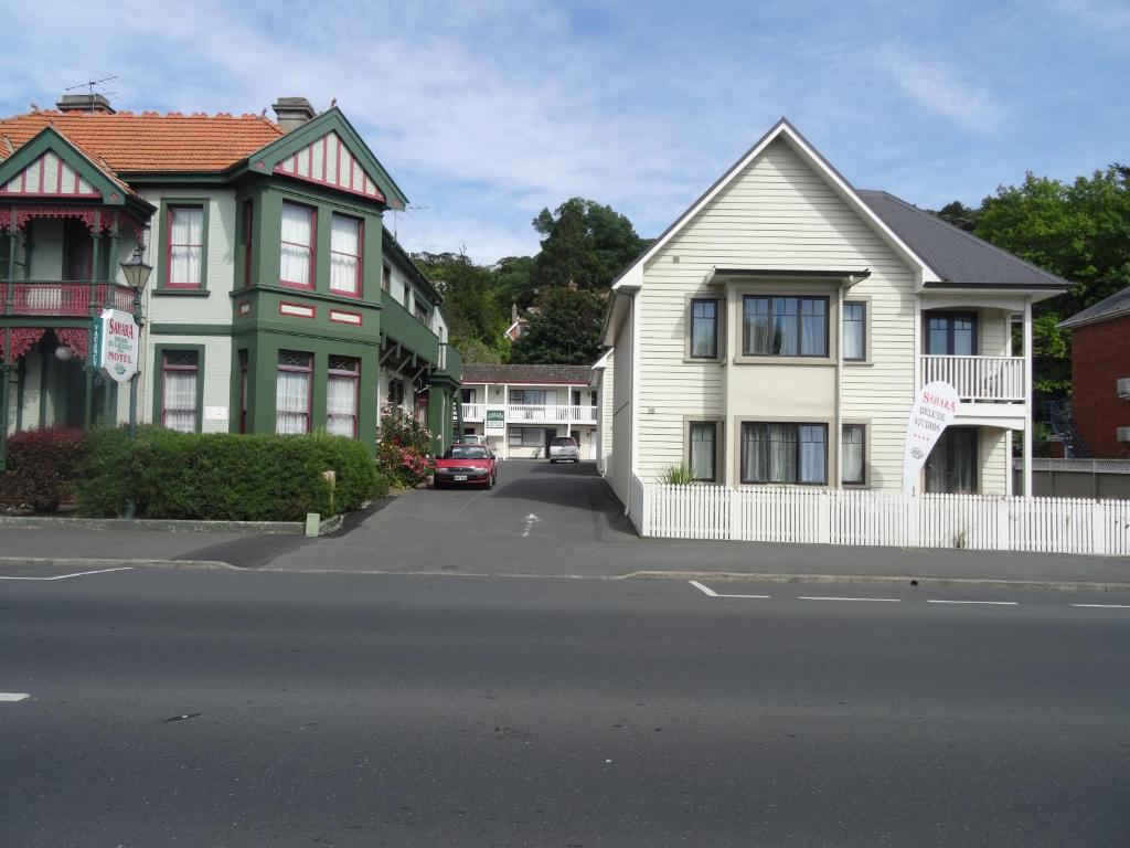 una fila de casas en una calle con un coche en Sahara Motels en Dunedin