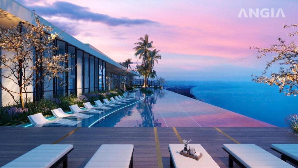 a hotel with a pool with a view of the ocean at Mita's House - The Sóng Apartment Vũng Tàu in Vung Tau