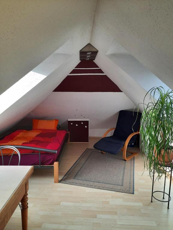 a attic room with two beds and a potted plant at Zentral u gemütlich über den Dächern von Braunschweig in Braunschweig