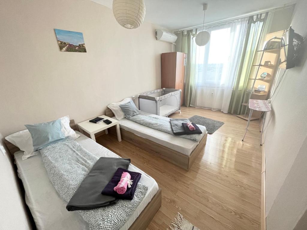 a living room with two beds and a couch at Airport Apartment in Sofia