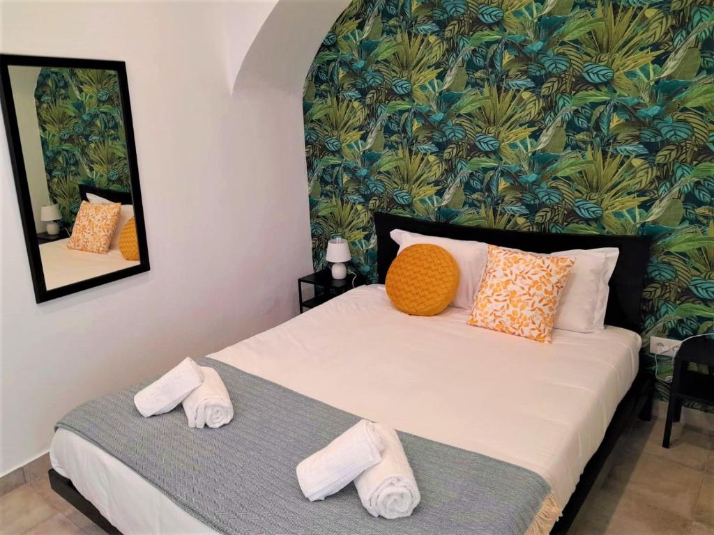 a bedroom with a bed with slippers on it at NatureHouse in Campo Maior