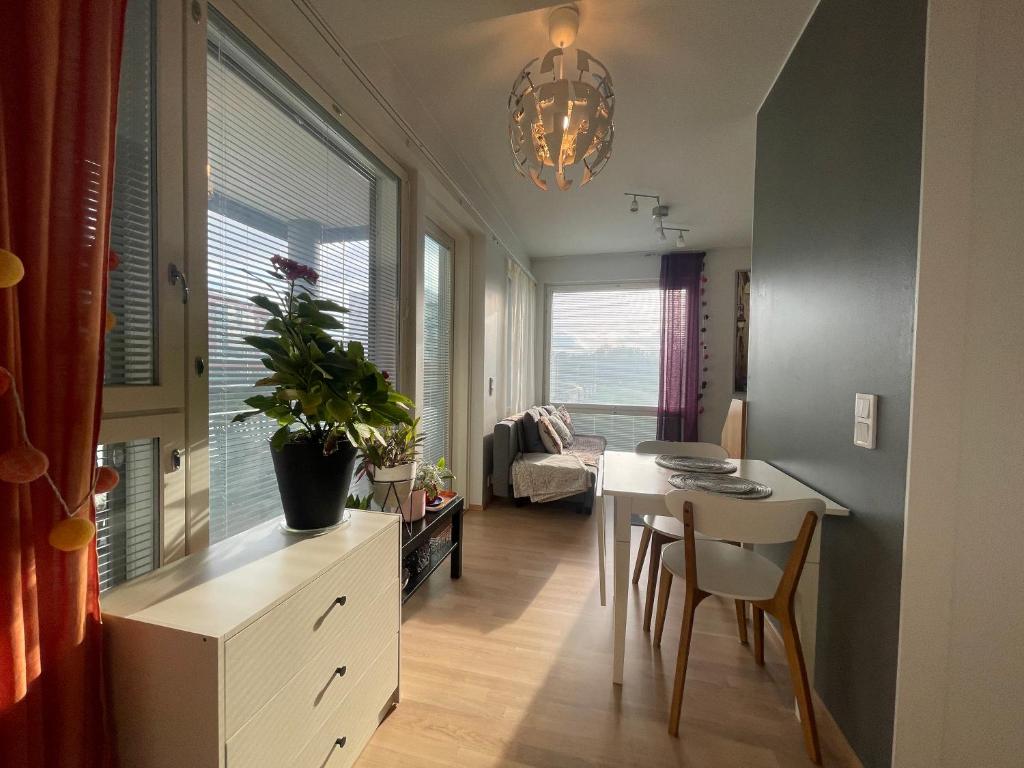 a living room with a table and a dining room at The Wildflower Apartment in Turku