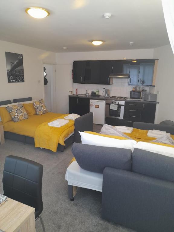 uma sala de estar com 2 camas e uma cozinha em Flat 4 Corner House em Doncaster