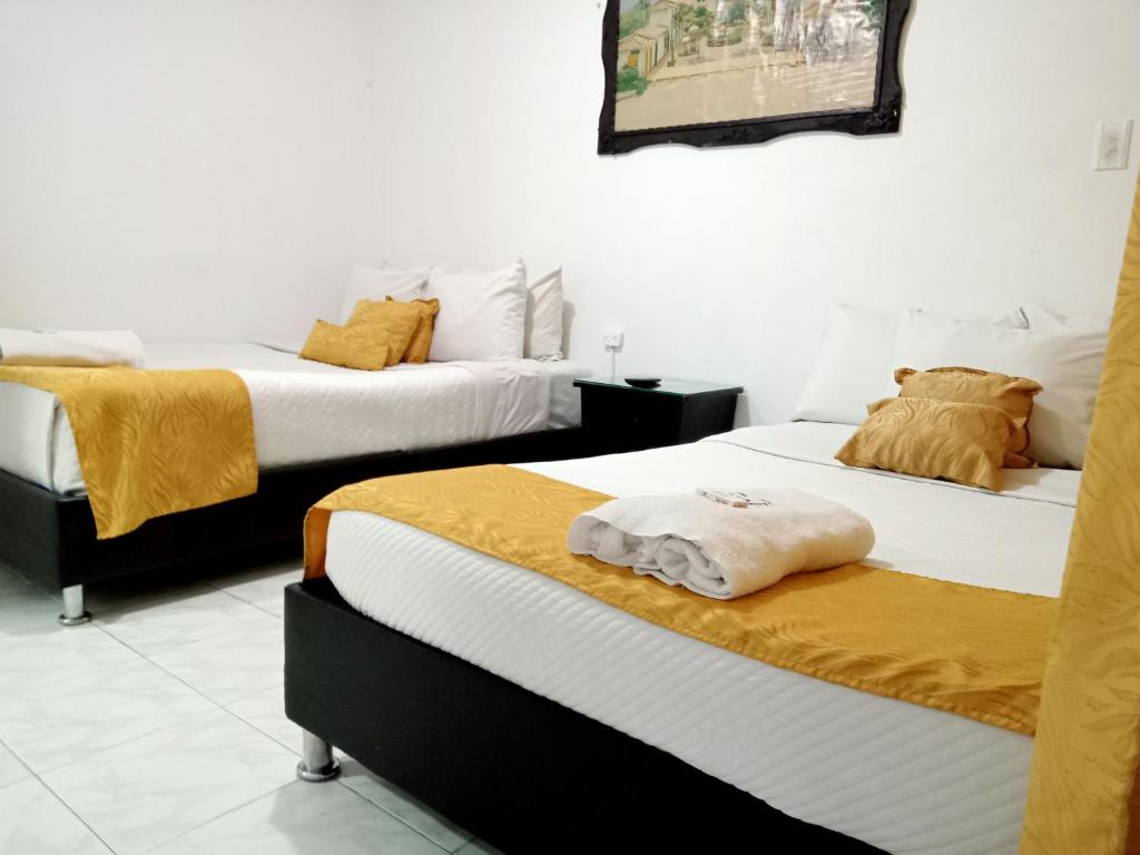 Postel nebo postele na pokoji v ubytování Hotel Casa Nini