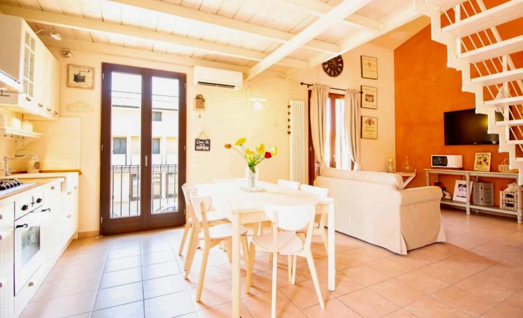 a kitchen and dining room with a table and chairs at Sweet home tuscany in Bientina