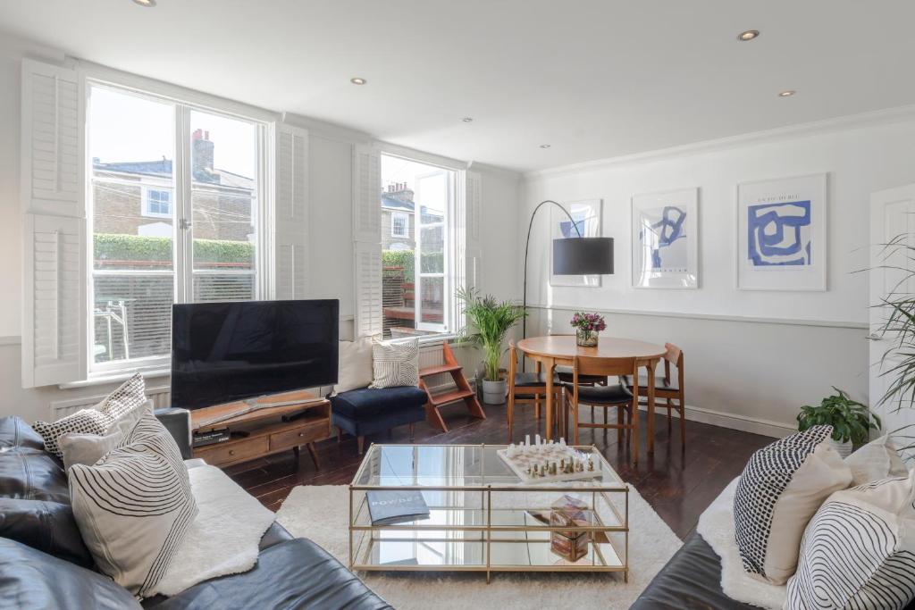 a living room with a couch and a table at The Dalston Maisonette in London