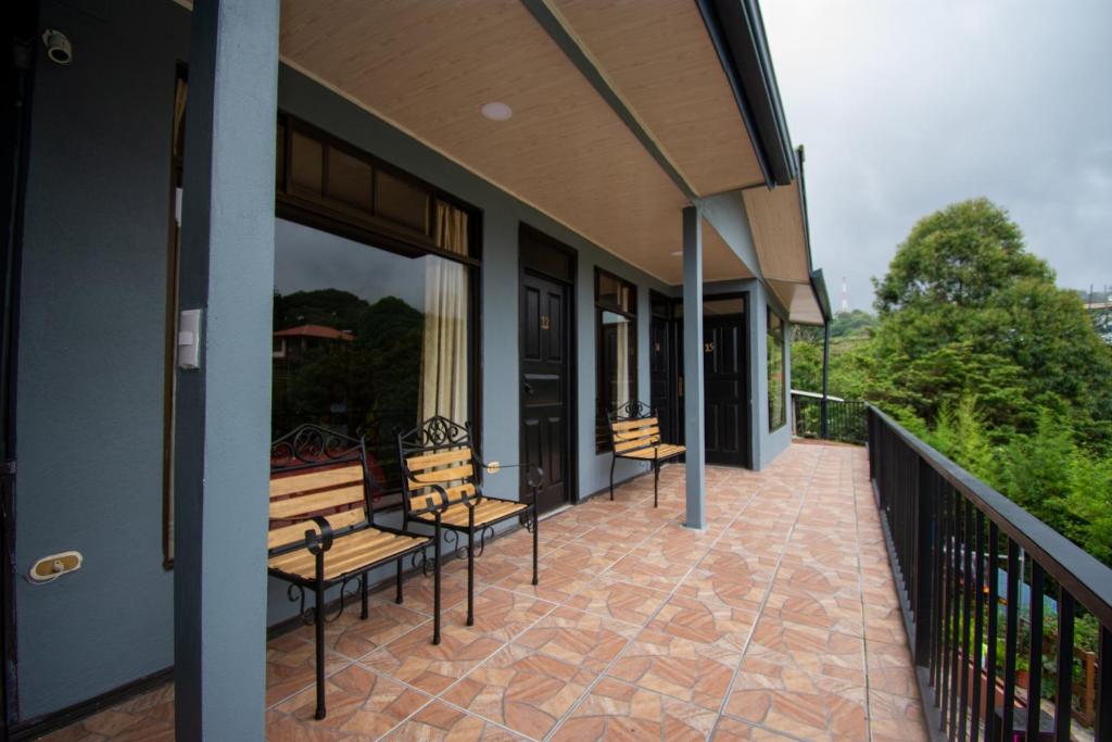 a porch with benches on a building at Cabinas Eddy B&B in Monteverde Costa Rica