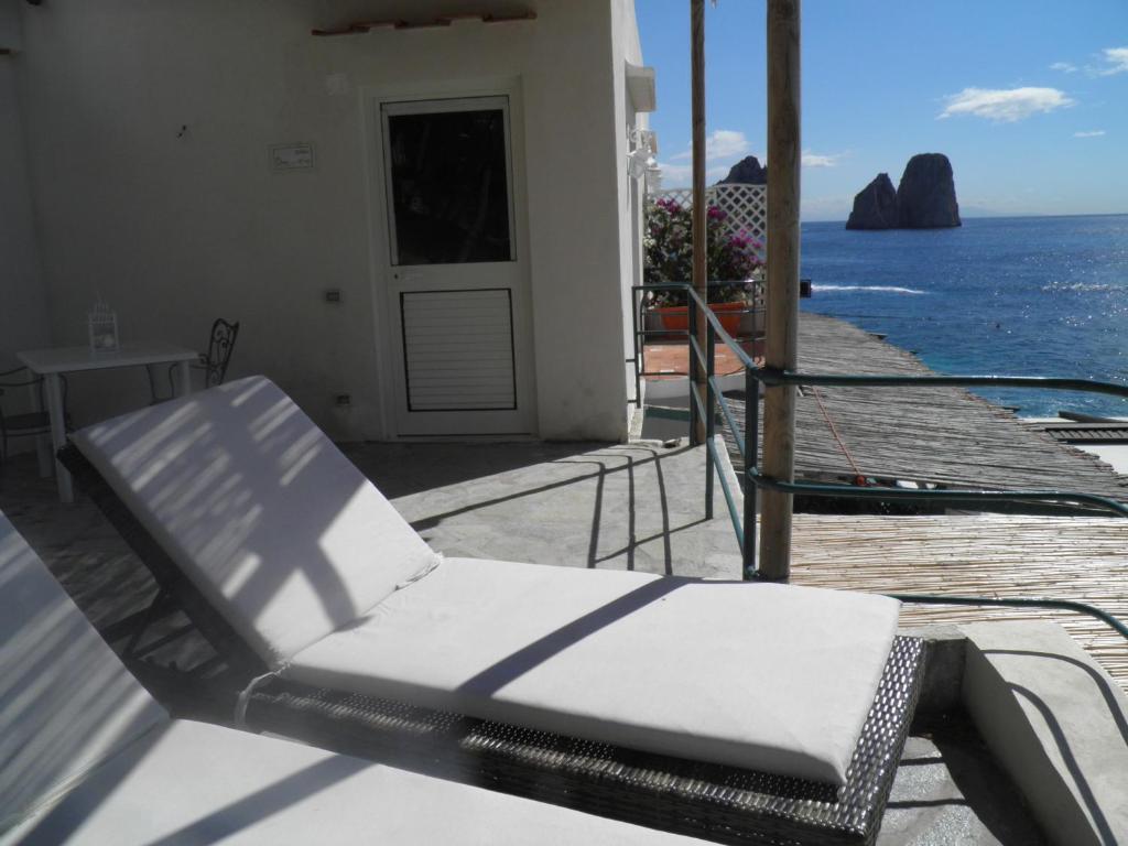 a balcony with a chair and the ocean at Diva La Canzone Del Mare in Capri