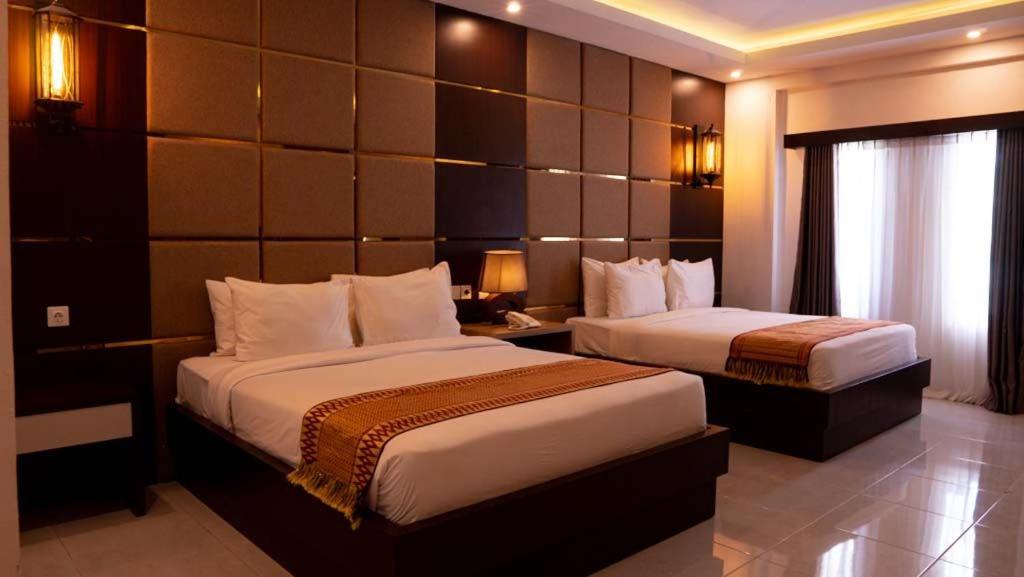 Een bed of bedden in een kamer bij Diva Lombok Resort