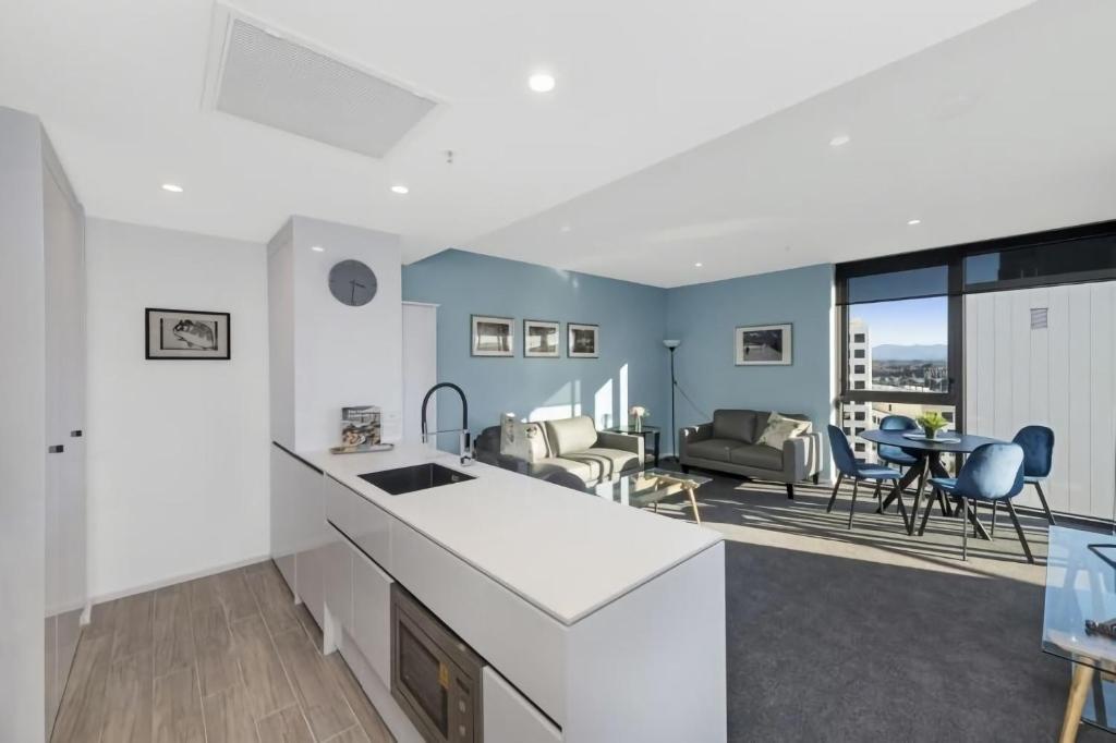 a kitchen and living room with a table and chairs at Accommodate Canberra - Highgate in Canberra