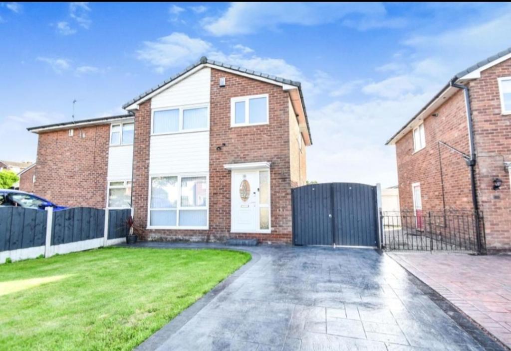 a brick house with a driveway in front of it at 3 bed House Lovely & Modern in Whitefield